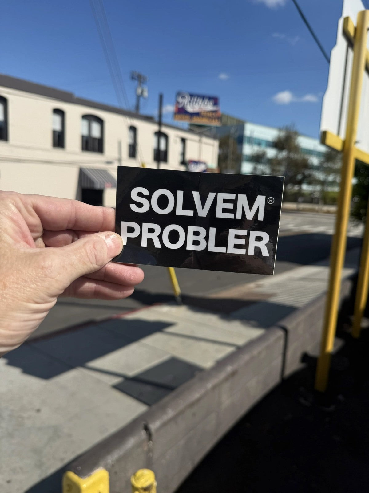 SOLVEM PROBLER® sticker held up outdoors