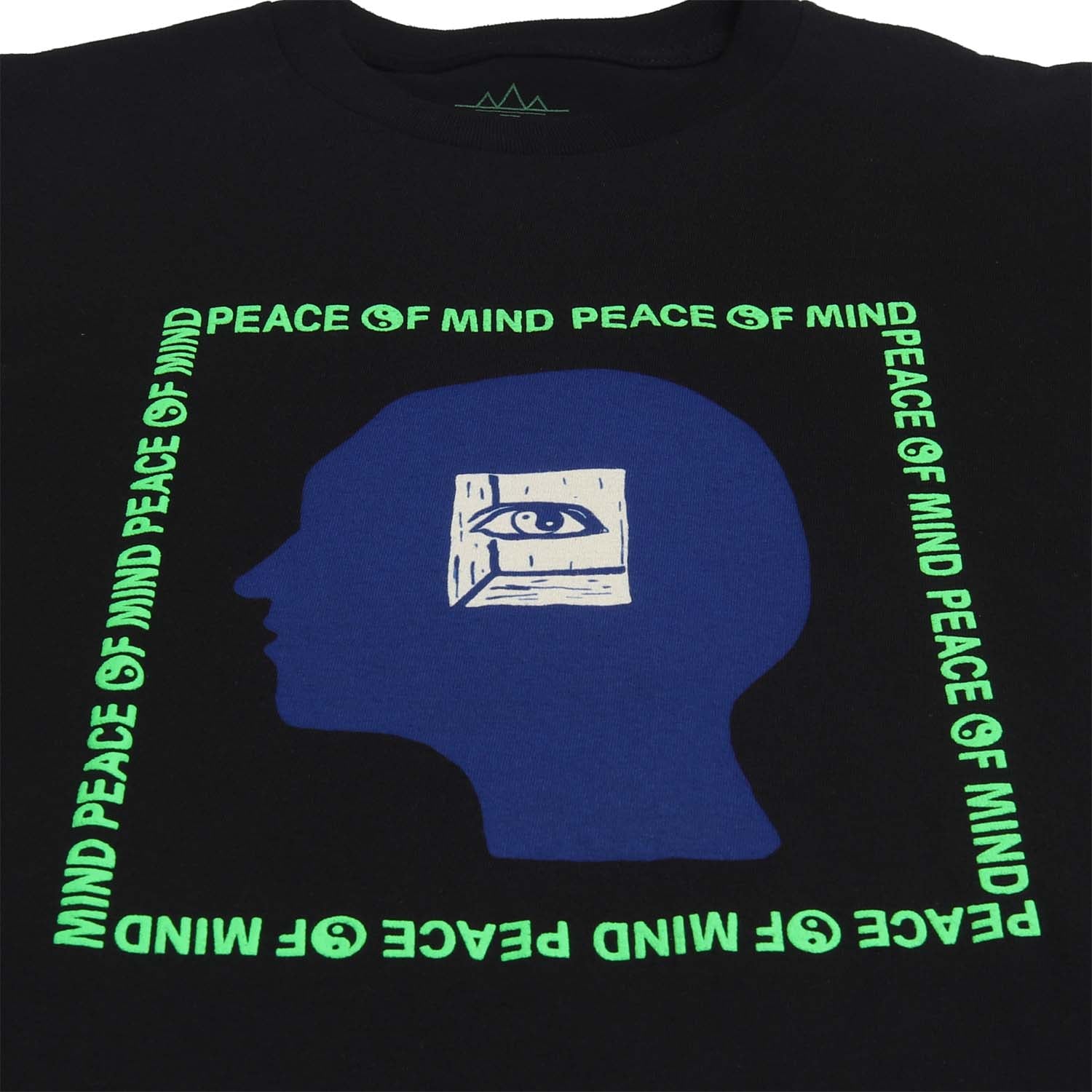 Peace of Mind text on black graphic tee. Yin Yang symbols in green puff ink. Graphic of a head with an inner eye over the head silhouette. graphic. Short sleeve black tee with green puff ink, blue head and white inner eye. Front detail of tee. Altru Apparel.