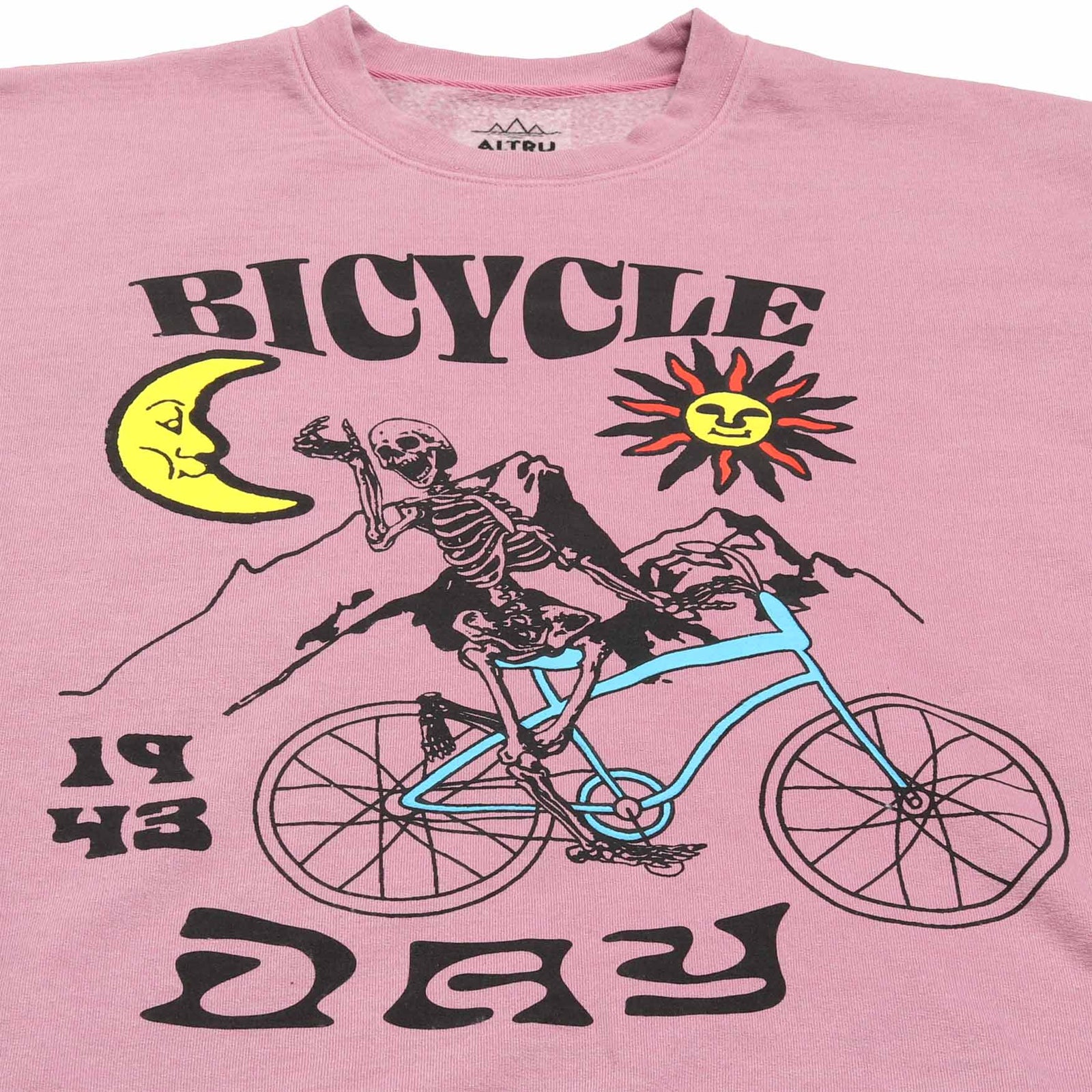 up close detail 1 of Altru mens pink fleece sweatshirt with a skeleton riding a bicycle graphic on front and the text "If the doors of perception were cleansed every thing would appear to man as it is, infinite." printed on the back.