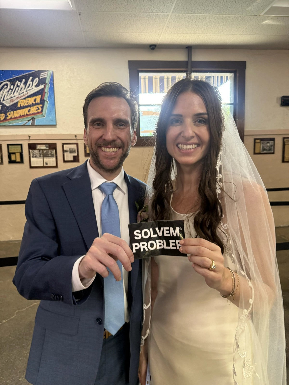 Newlyweds holding a SOLVEM PROBLER® sticker
