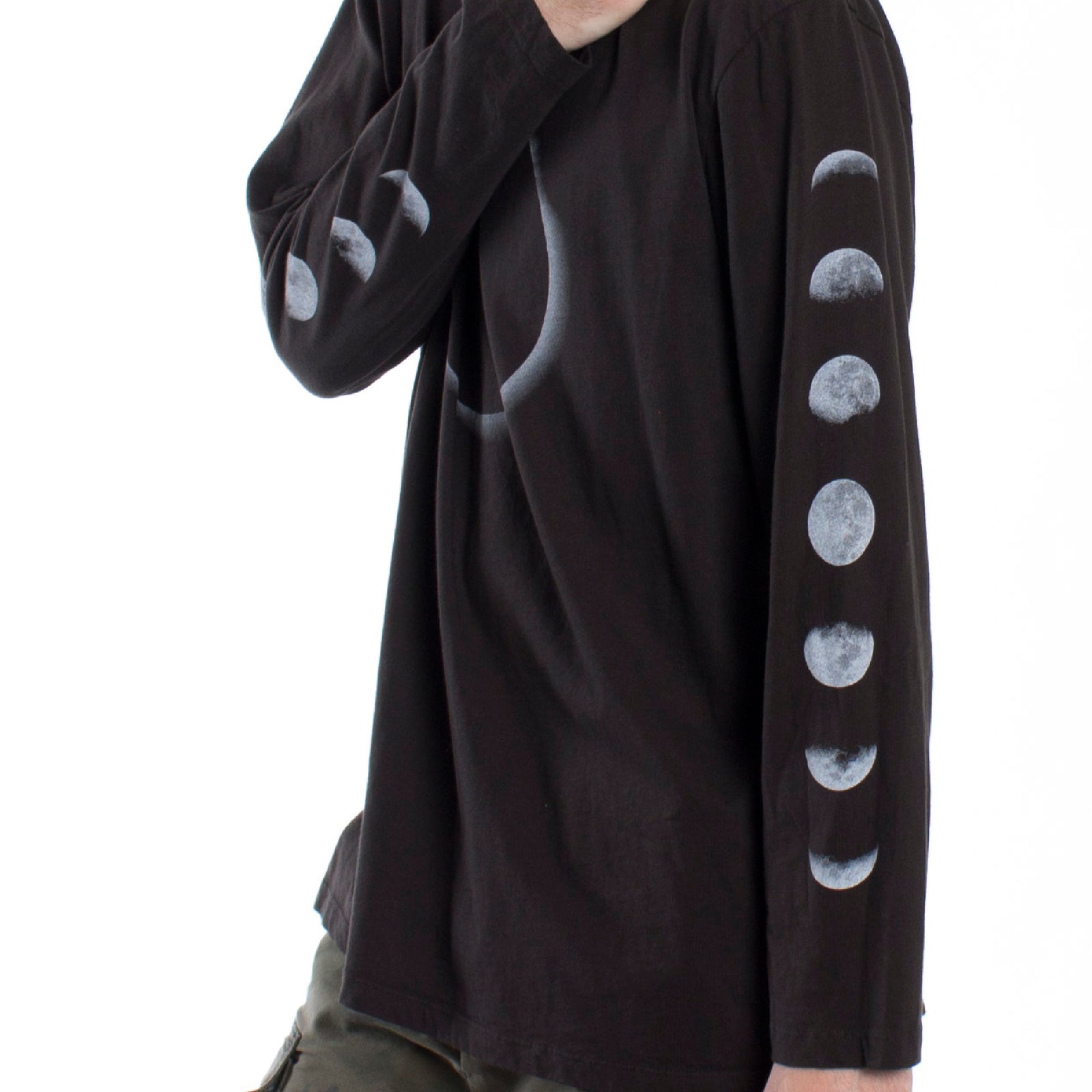 Full front male model side photo of Lunar graphic phases long sleeve tee printed on both sleeves with a large eclipse graphic on front chest.