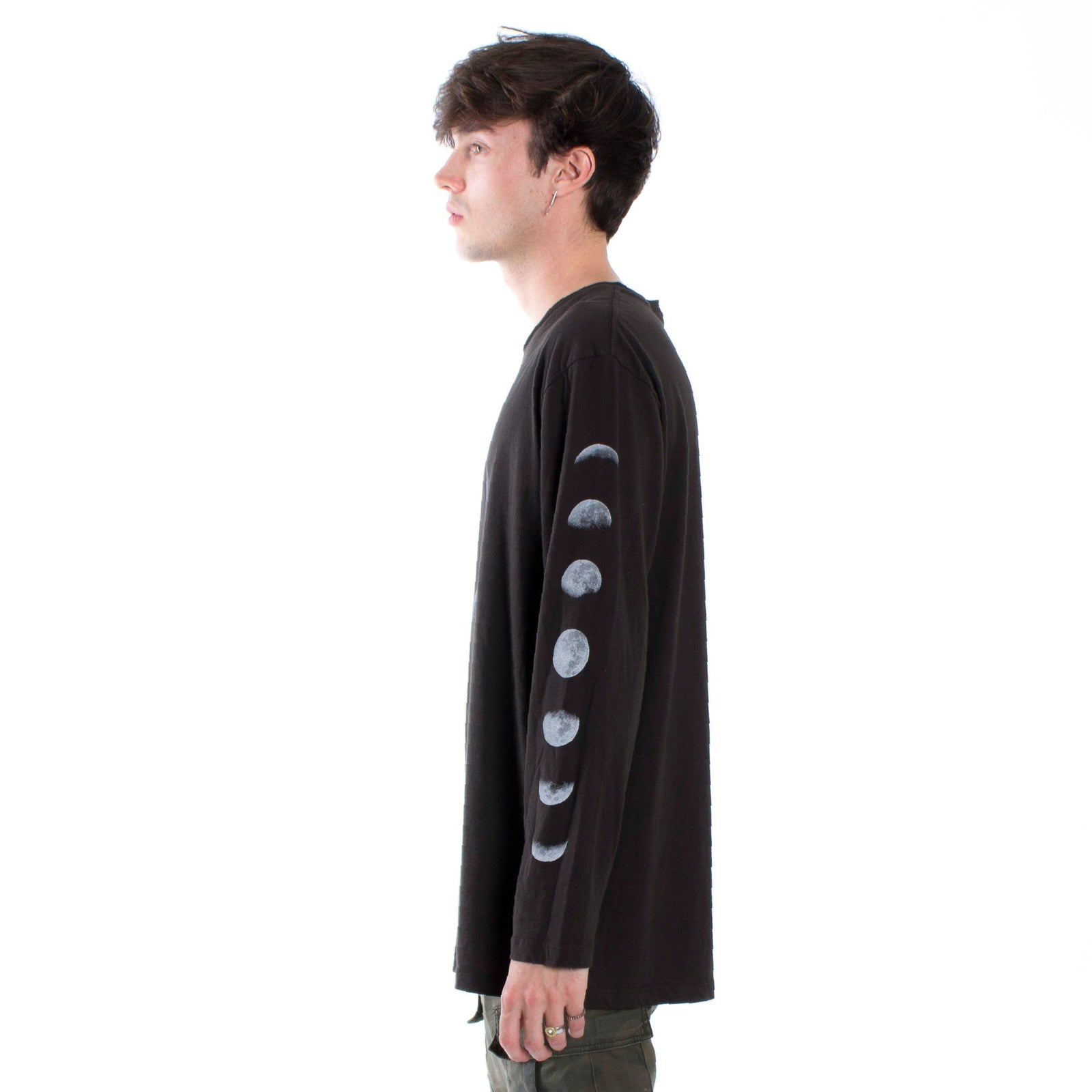 Full front male model side photo left of Lunar graphic phases long sleeve tee printed on both sleeves with a large eclipse graphic on front chest.
