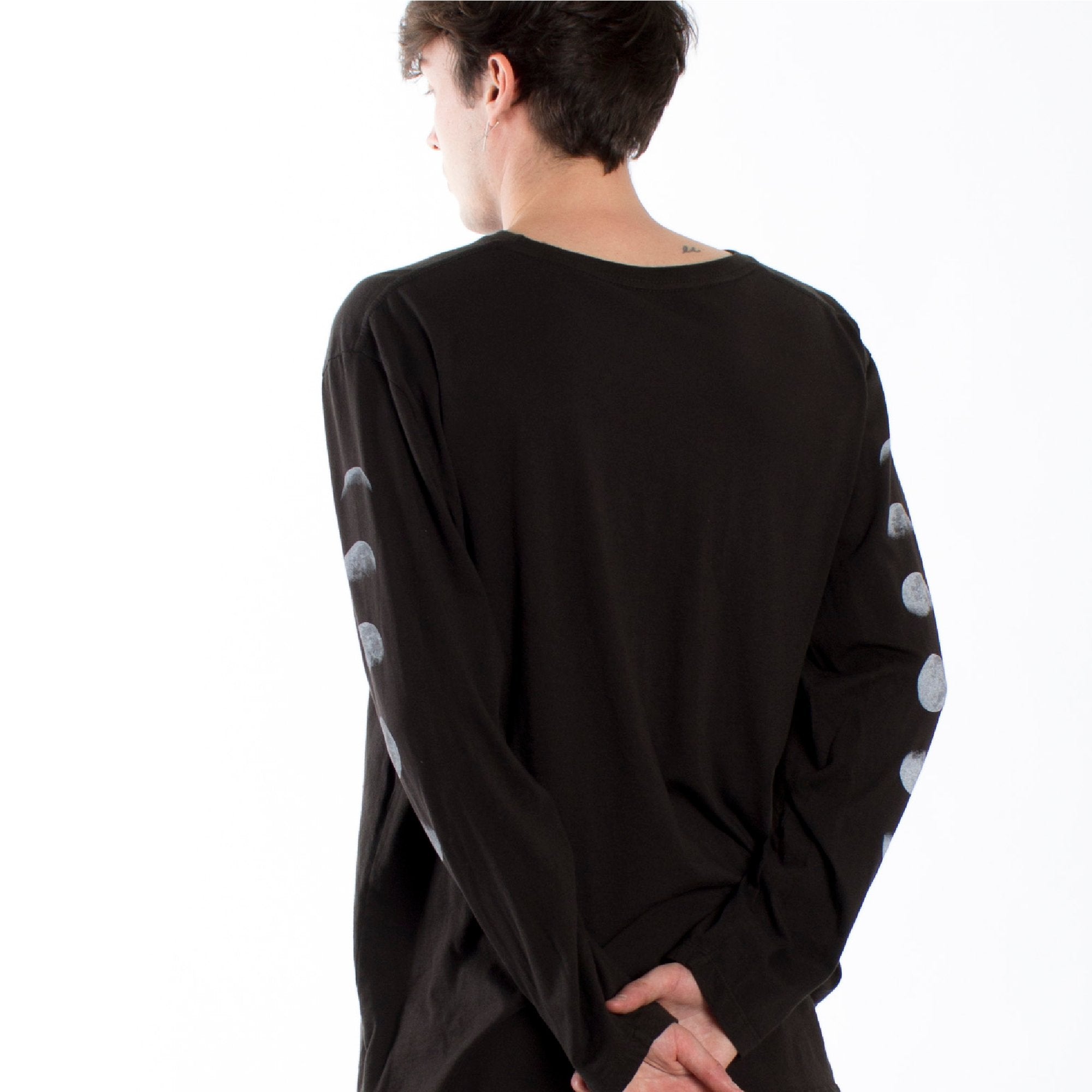 Full front male model photo back of Lunar graphic phases long sleeve tee printed on both sleeves with a large eclipse graphic on front chest.