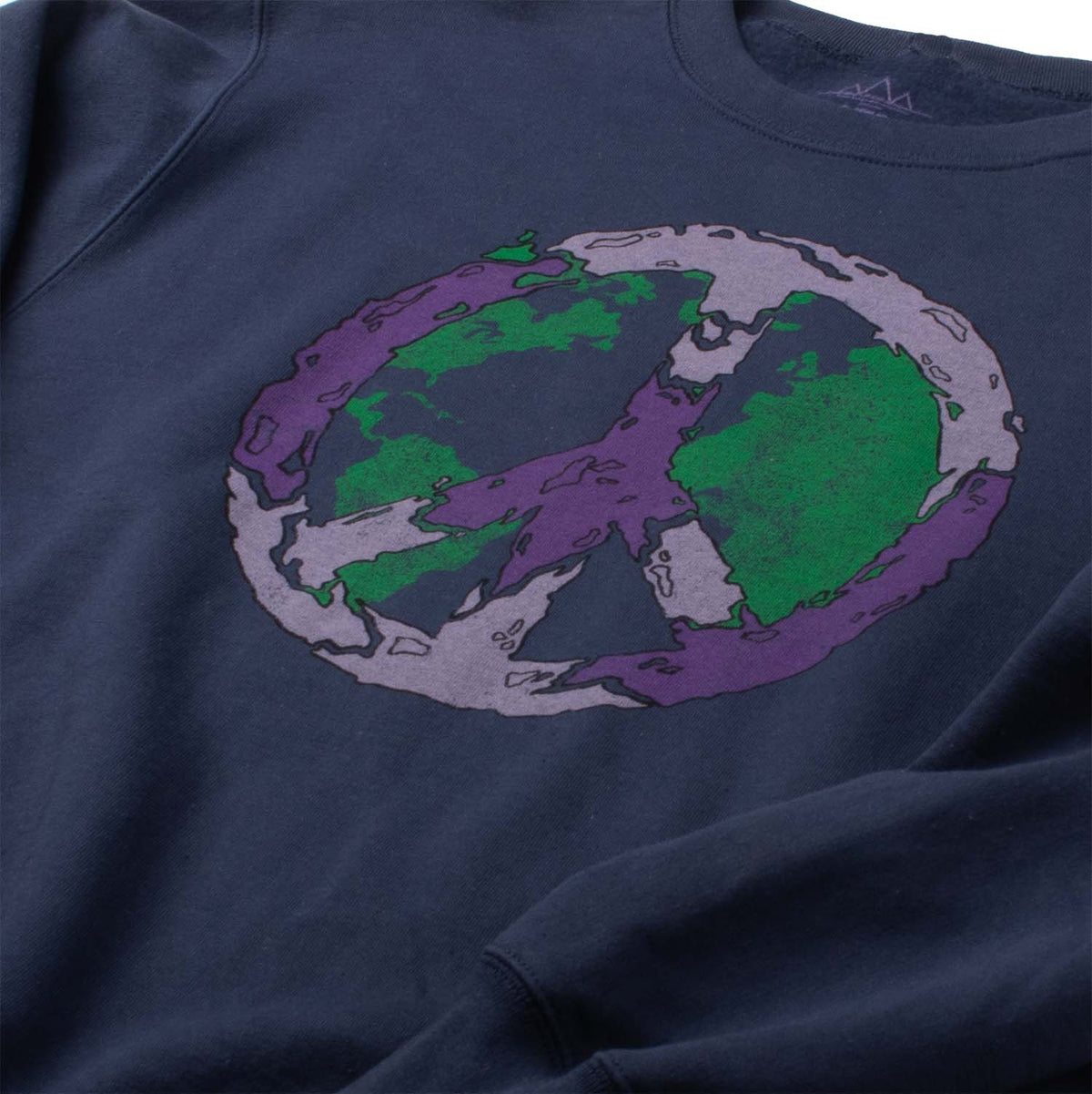 Angled closeup Photo of sweatshirt chest graphic. Peace vibes fleece sweatshirt of Earth covered with the peace sign. Screen printed graphic on front of comfortable navy-blue super soft fleece.