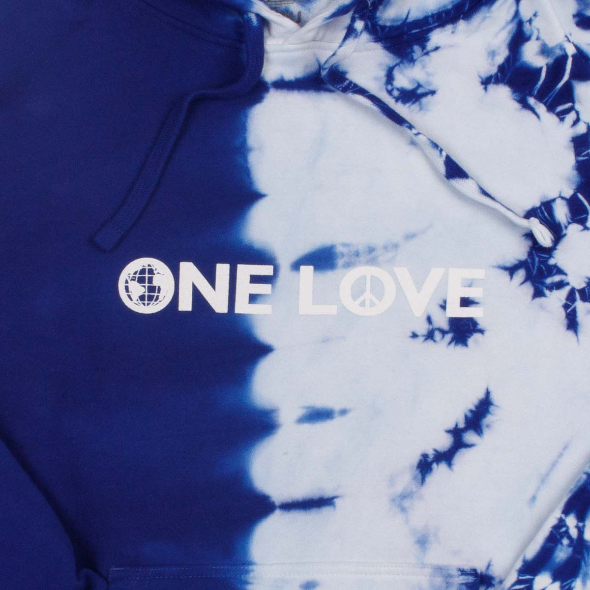 Closeup detail photo of text on asymmetrical half tie-dyed blue, white hoodie. The "ONELOVE" text is printed with high density ink.