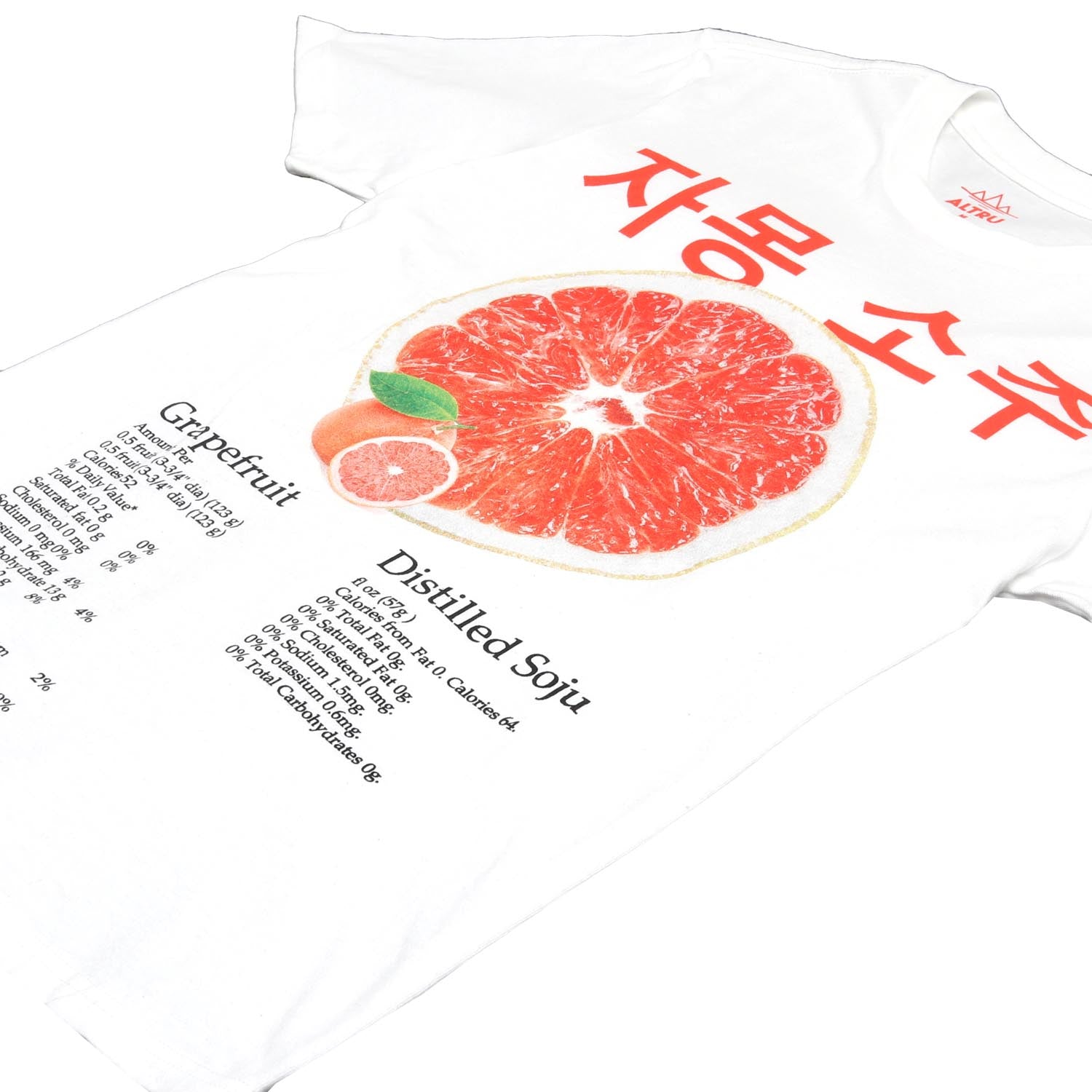 White tee with graphic on front in shades of pink-red grapefruit. Korean writing above a grapefruit graphic that translates into English "Grapefruit Soju". Below the grapefruit graphic are the product label information listing calories and the other typical label information. Grapefruit Soju is a Korean distilled drink that is delicious and refreshing. Front detail image angled. By Altru Apparel.