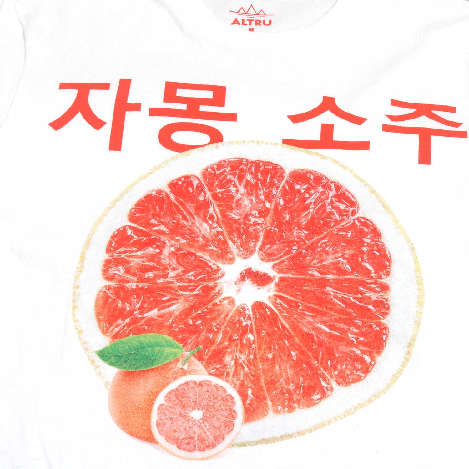 White tee with graphic on front in shades of pink-red grapefruit. Korean writing above a grapefruit graphic that translates into English "Grapefruit Soju". Below the grapefruit graphic are the product label information listing calories and the other typical label information. Grapefruit Soju is a Korean distilled drink that is delicious and refreshing. Full front image. By Altru Apparel.