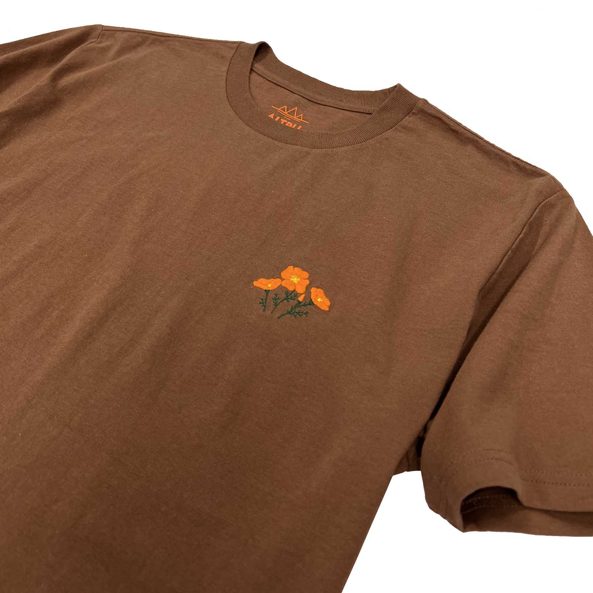 Altru,  Small Poppy Embroidery on a brown shirt. front image close up